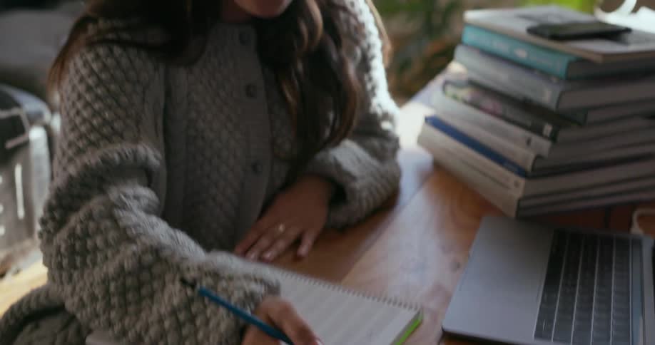 A woman composes a song using a keyboard