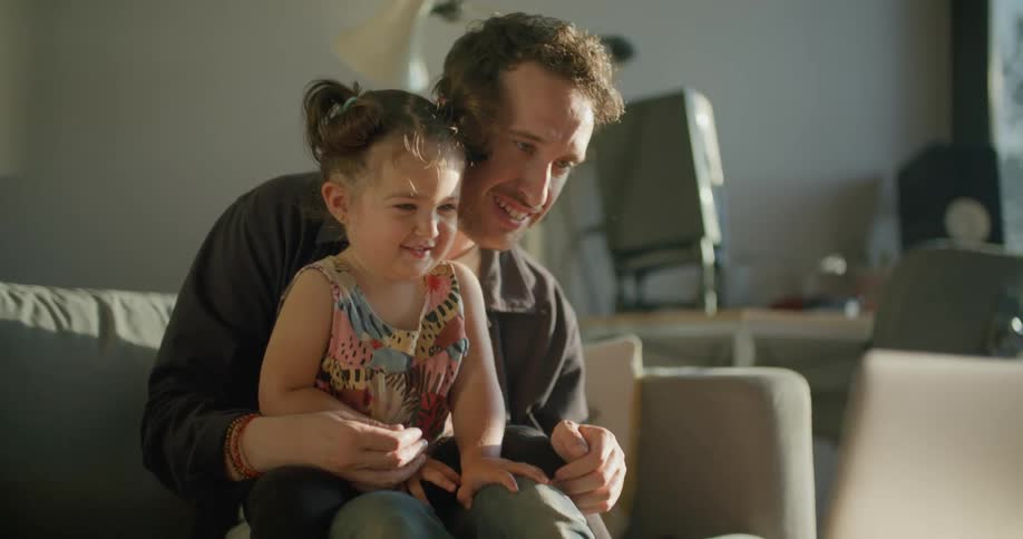 Father and daughter talk to others via video call