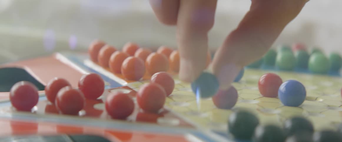 Person playing playing chinese checkers