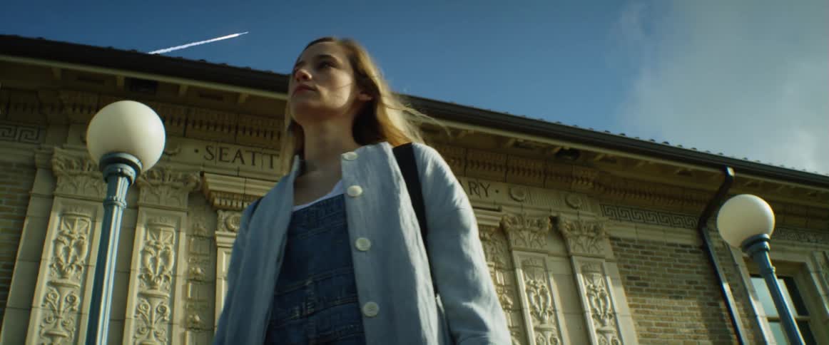 A woman walks from a building