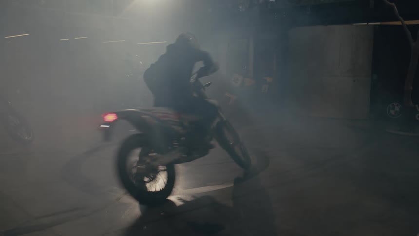 A man is doing doughnuts in the garage