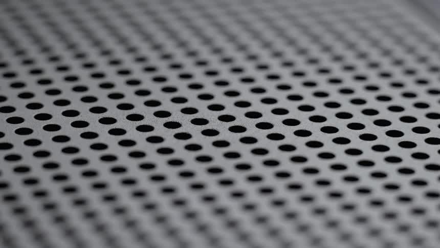 A grate made up of small circular holes