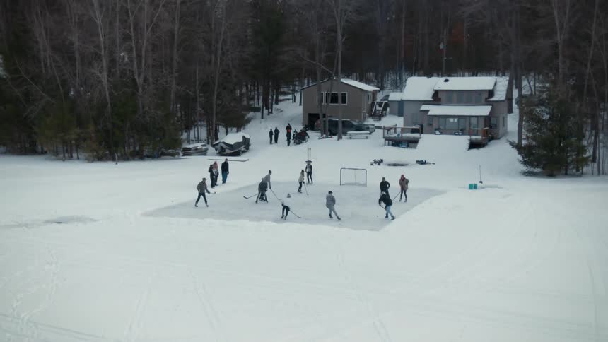 People playing ice hockey outdoors