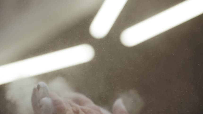 A person rubs powder on his hands