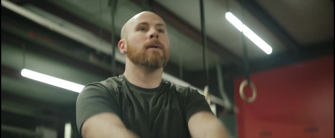 A man working out with a kettle bell in a gym