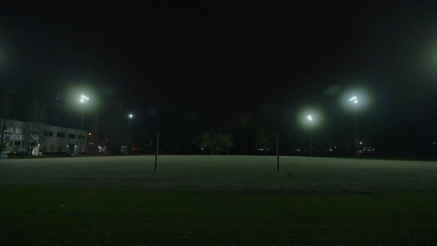 The soccer field is empty at night