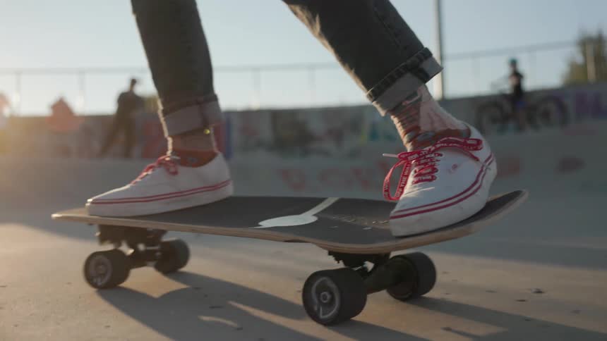 A girl is skateboarding in the park
