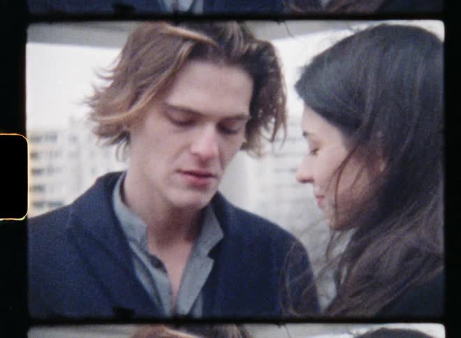 A couple hold hands and look into each others eyes