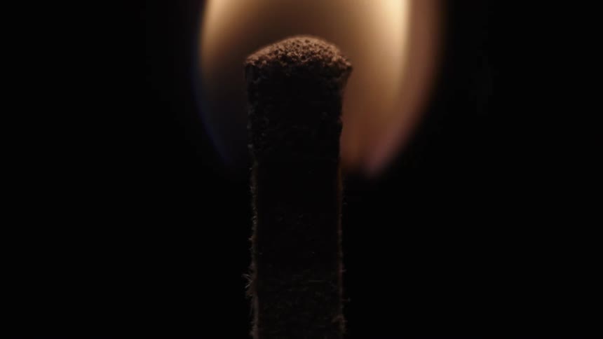 A match is lit in the dark
