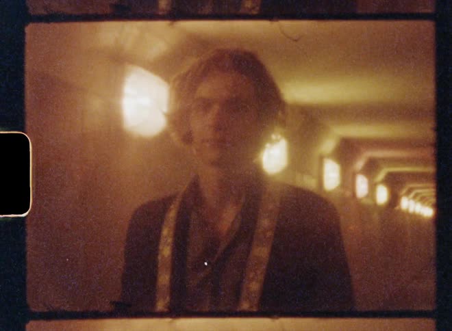 Young man walking down a tunnel caught on vintage film