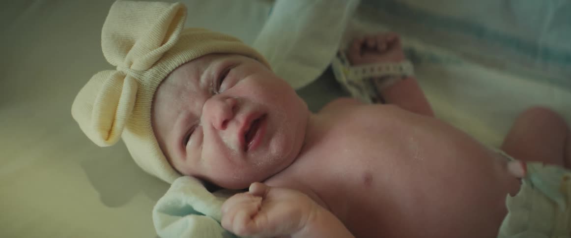 The newborn is resting in the crib