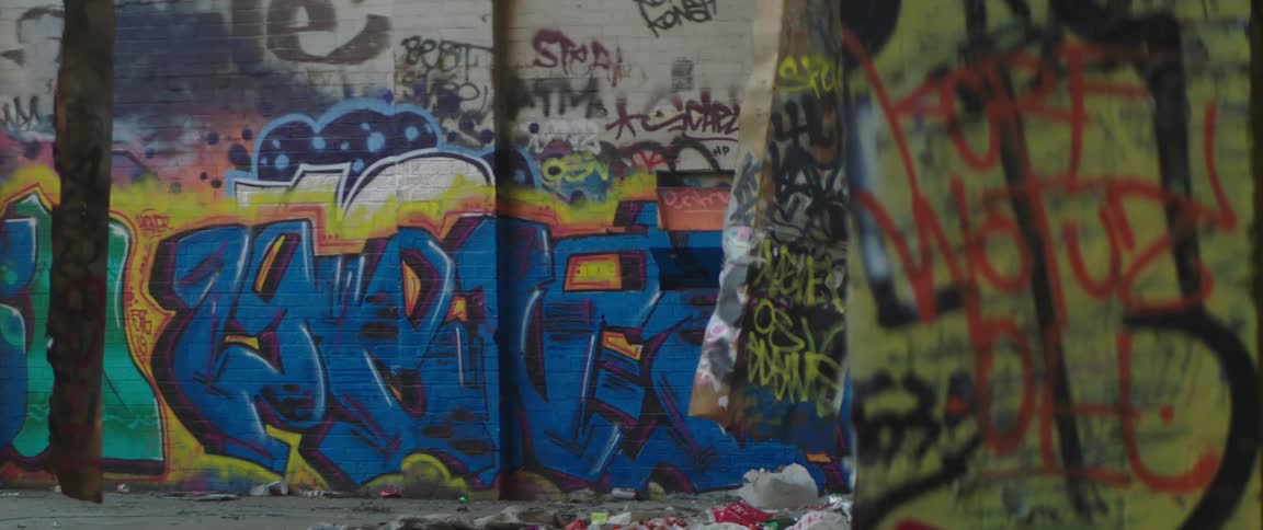 Colorful graffiti letters cover building walls