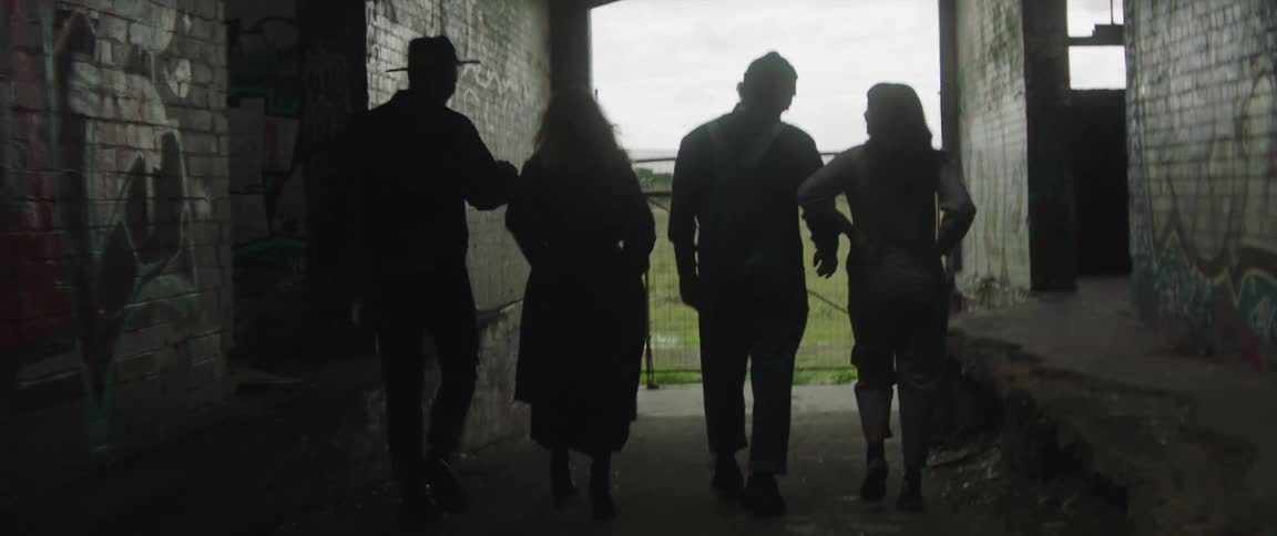 A group of people walking down a ramp in a building