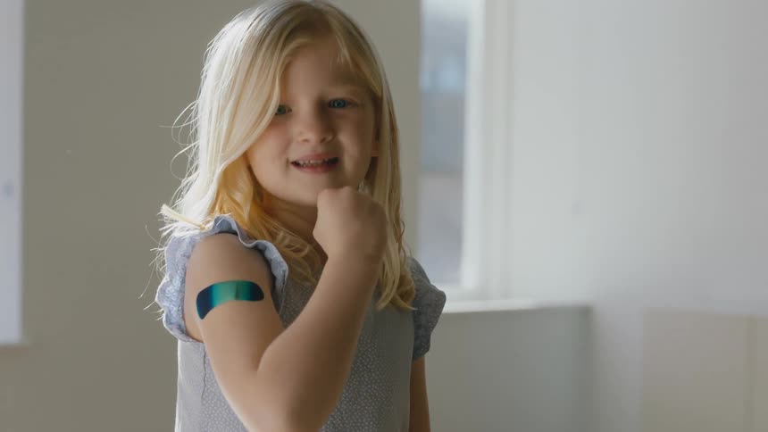 Young blonde girl gets vaccinated