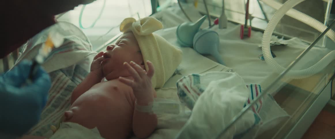 A nurse checks on a newborn baby in the hospital