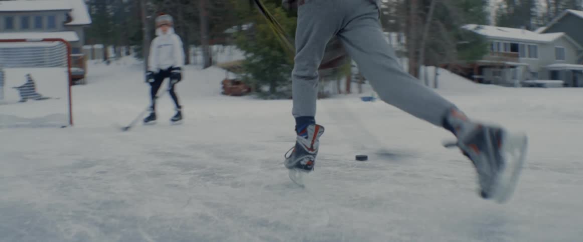 People are playing hockey on the frozen water