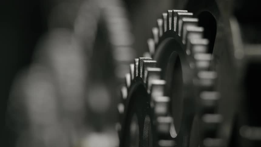 Gears of different sizes move in unison on a piece of equipment