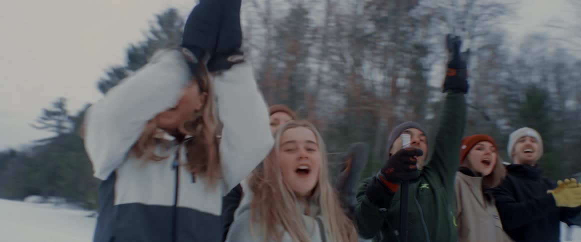 A group of people are celebrating together outdoors in winter