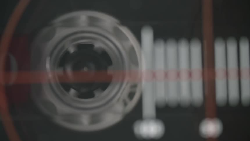Cassette player spool rotates behind white tick marks