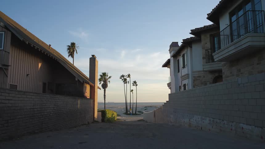 The sun is setting in the city near the coast