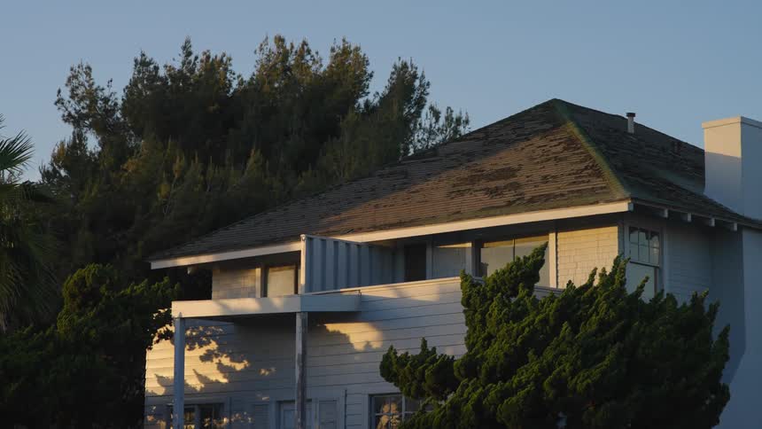 The outside of a home with trees around it