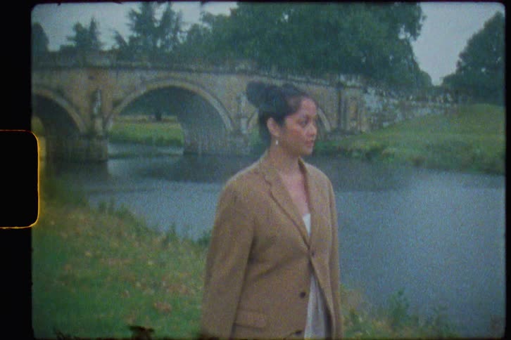 Footage of a woman walking outdoors in spring is displayed on film