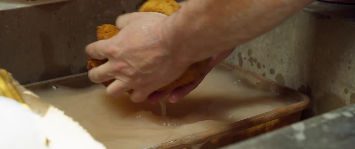 A person is washing their hands with a sponge