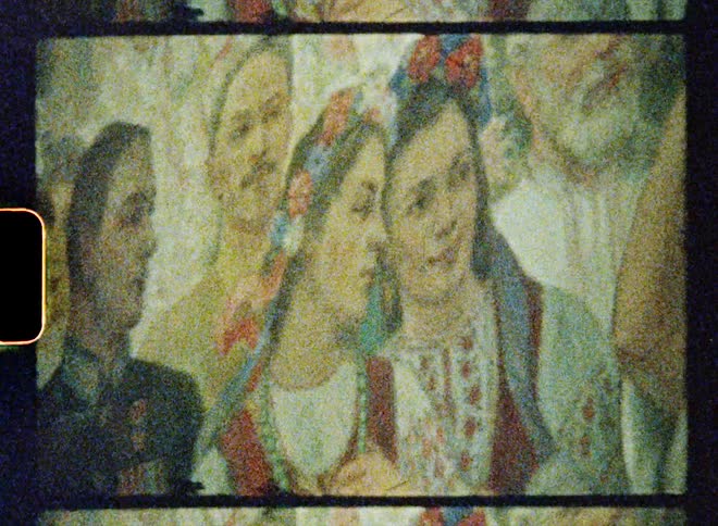 A painting of people is on the wall