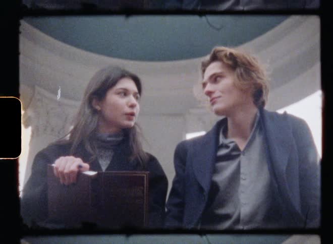 A woman is reading a book to a man