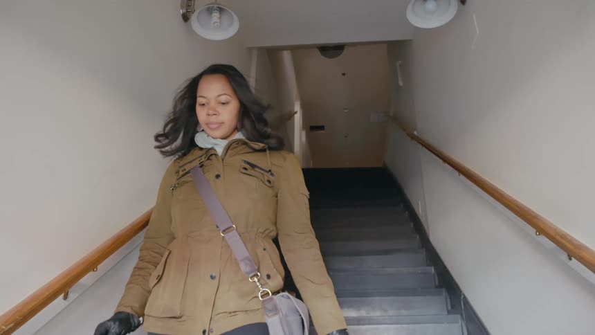 A woman walks down the stairs