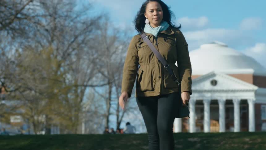 A woman walks across the field
