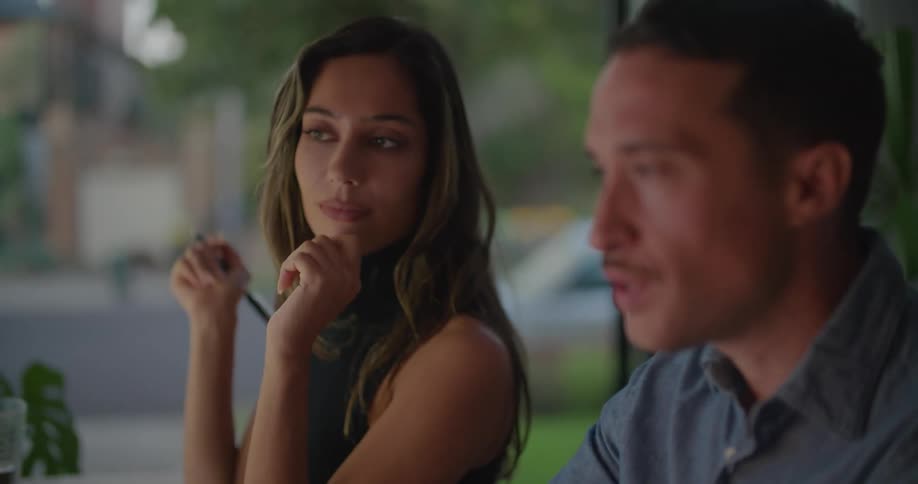 Man and woman are talking together and sitting near a window