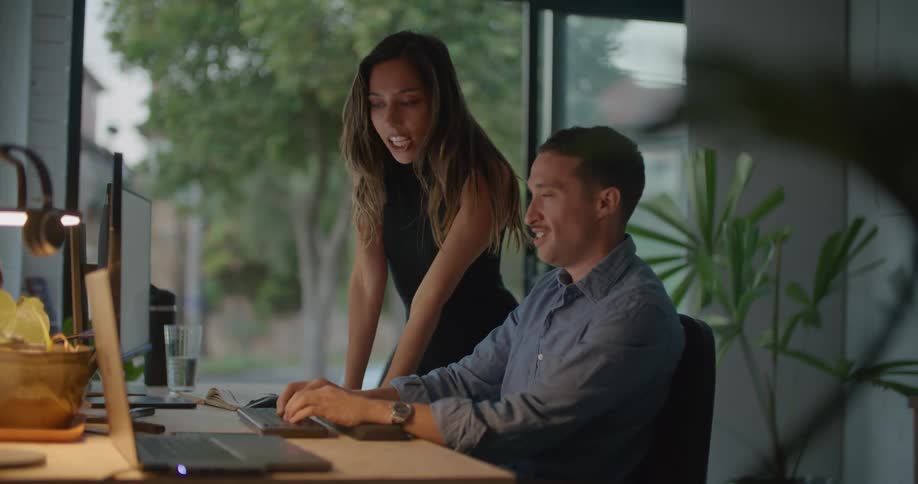 Man and woman are communicating and typing on a computer