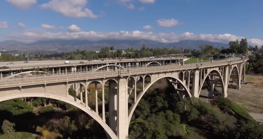 Cars traveling over a highway during the day