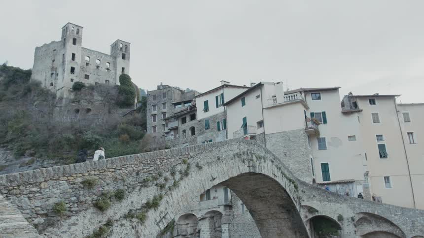 A view of two people walking up a bridge outdoors