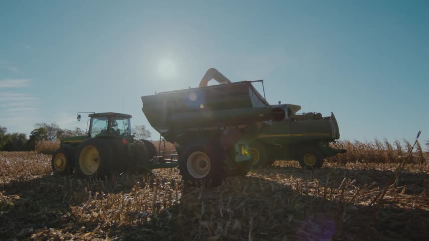 Farm tractors are parked on an empty field