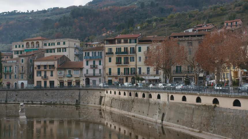 Traffic on an italian street near the water and buildings