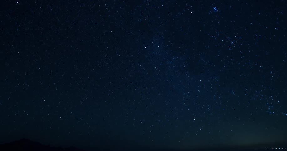 Stars twinkle in the night sky and there is one very bright star shining