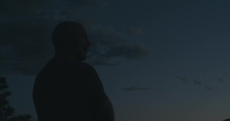 A man is watching the sunset