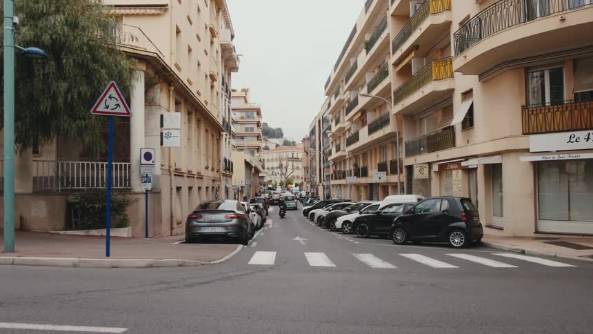 Cars are driving through a downtown city during spring
