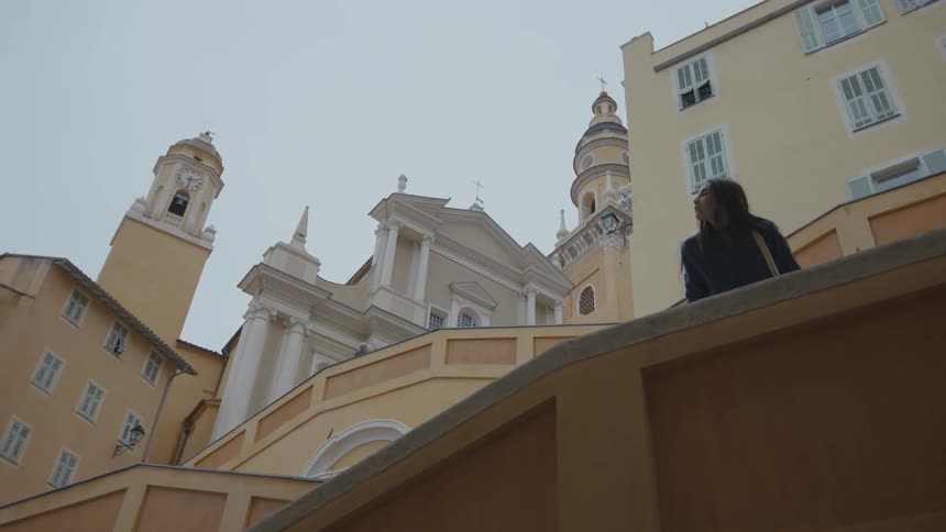 A woman walks by the building