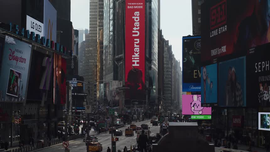People walking and cars traveling on the busy streets of new york times square