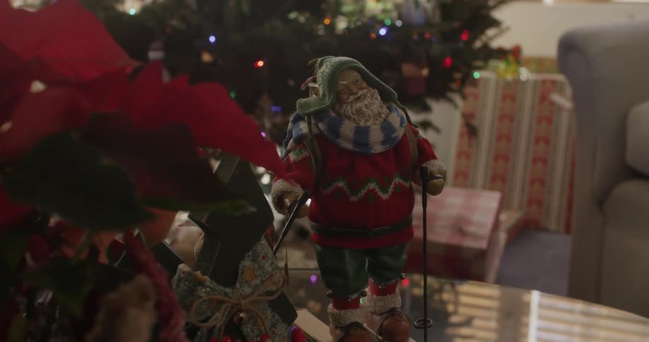A santa statue sits on a glass table
