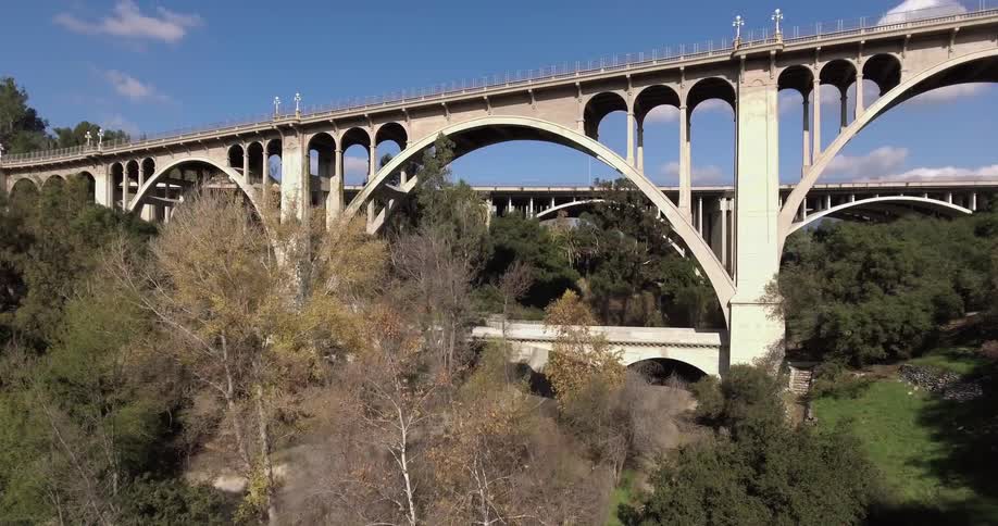 Two bridges have cars driving over them in the distance