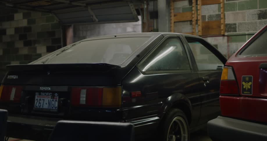 Two cars parked in a home garage