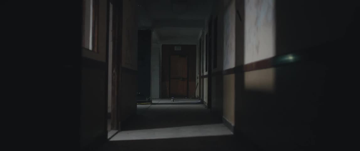 Light from windows shines in the hallway of an old apartment building