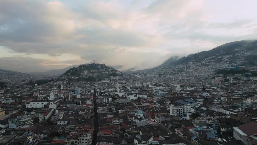 Aerial view of city buildings with hill and mountain