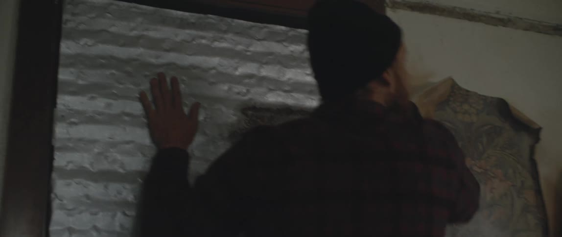 A man running to a door and slamming on it