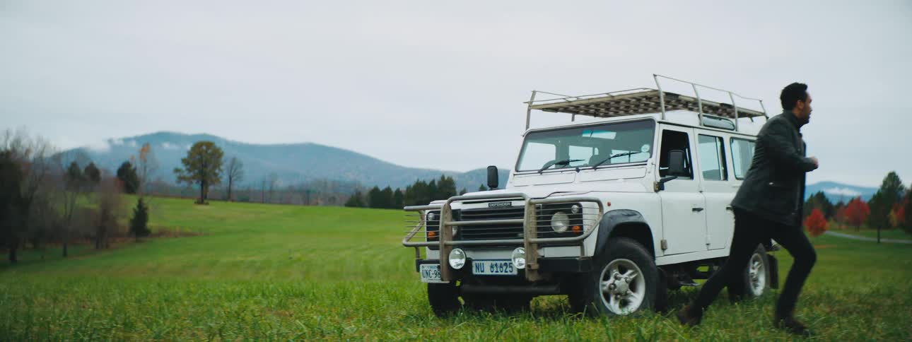 Man jumps from his range rover parked in a field