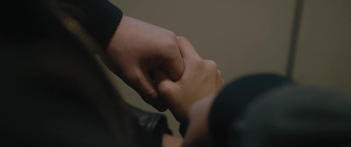 A person has their hands clasped together